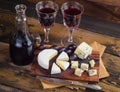 Cheese plate with grape and wine on wood Royalty Free Stock Photo