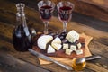 Cheese plate with grape and wine on wood Royalty Free Stock Photo
