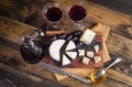 Cheese plate with grape and wine on wood Royalty Free Stock Photo