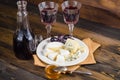 Cheese plate with grape and wine on wood