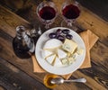 Cheese plate with grape and wine on wood Royalty Free Stock Photo