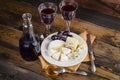 Cheese plate with grape and wine on wood Royalty Free Stock Photo