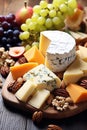 Cheese plate with grapes and nuts. Selective focus. Royalty Free Stock Photo