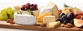 Cheese plate with grapes and nuts. Selective focus. Royalty Free Stock Photo