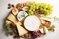 Cheese plate with grapes and nuts. Selective focus. Royalty Free Stock Photo