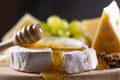 Cheese plate, honey pouring on camembert cheese Royalty Free Stock Photo