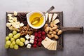 Cheese plate with nuts, honey and grapes Royalty Free Stock Photo