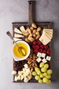 Cheese plate with nuts, honey and grapes Royalty Free Stock Photo