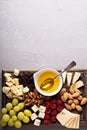 Cheese plate with nuts, honey and grapes Royalty Free Stock Photo