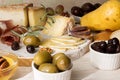 Cheese plate with pieces moldy cheese, prosciutto, pickled plums Royalty Free Stock Photo