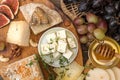 Cheese plate with pieces moldy cheese, prosciutto, pickled plums Royalty Free Stock Photo