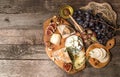 Cheese plate with pieces moldy cheese, prosciutto, pickled plums Royalty Free Stock Photo