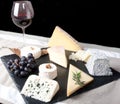 Cheese Plate with Red Wine, vine and Honey on black background