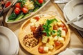 Cheese plate in a restaurant at a banquet. Table setting with appetizers. Wooden tray with sliced cheeses