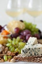 Cheese plate served with grapes, jam, cured melon, crackers and Royalty Free Stock Photo