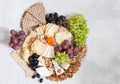 Cheese plate served with grapes, jam, cured melon, crackers and Royalty Free Stock Photo