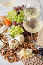 Cheese plate served with grapes, jam, cured melon, crackers and Royalty Free Stock Photo