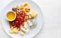 Cheese plate served with grapes and nuts. Assorted cheeses Camembert, Brie, Parmesan blue cheese, goat Royalty Free Stock Photo