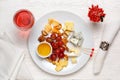 Cheese plate served with grapes, nuts and a glass of rose wine. Assorted cheeses Camembert, Brie, Parmesan blue cheese, goat Royalty Free Stock Photo