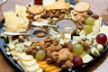 Cheese plate served with nuts, grapes, honey and crackers Royalty Free Stock Photo