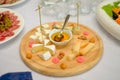 Cheese plate served with white wine, crackers and nuts, Top view. Assorted cheeses Camembert, Brie, Parmesan blue cheese Royalty Free Stock Photo