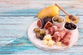 Cheese plate with Slices of prosciutto, pieces of cheese, olives Royalty Free Stock Photo