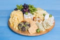 Cheese plate variation on a wooden blue table Royalty Free Stock Photo