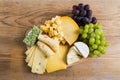 Cheese plate variation on a wooden table Royalty Free Stock Photo