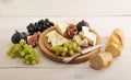 Cheese plate - various types of cheeses and figs and grapes on a Royalty Free Stock Photo