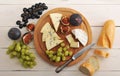 Cheese plate - various types of cheeses and figs and grapes on a Royalty Free Stock Photo