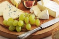 Cheese plate - various types of cheeses and figs and grapes on a Royalty Free Stock Photo