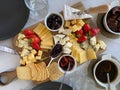 cheese plateCheese plate with camembert, brie, dor blue, strawberries, sun-dried tomatoes, olives on a wooden table, top