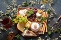 Cheese platter with assorted cheeses, grapes, nuts and snacks Royalty Free Stock Photo