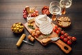 Cheese platter with brie, Camembert, grapes, olives and tomatoes