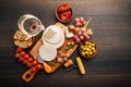 Cheese platter with brie, Camembert, grapes, olives and tomatoes