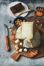 Cheese platter with cheese assortment, nuts, honey and bread