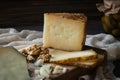 Cheese platter of chopped Spanish hard cheese manchego and sliced Italian pecorino toscano on wooden board with walnuts Royalty Free Stock Photo