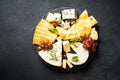 Cheese platter with craft cheese assortment at black background. Royalty Free Stock Photo