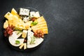 Cheese platter with craft cheese assortment at black background. Royalty Free Stock Photo