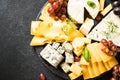 Cheese platter with craft cheese assortment on slate board.