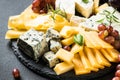 Cheese platter with craft cheese assortment on slate board. Royalty Free Stock Photo