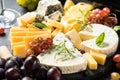 Cheese platter with craft cheese assortment on slate board. Royalty Free Stock Photo