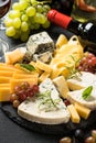Cheese platter with craft cheese assortment on slate board. Royalty Free Stock Photo