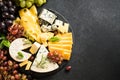 Cheese platter with craft cheese assortment on slate board. Royalty Free Stock Photo