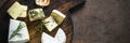 Cheese platter on dark stone table.