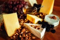 Cheese platter with different cheeses, grapes, nuts, honey, brea Royalty Free Stock Photo