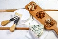 A cheese platter featuring blue vein and camembert cheeses on the wooden background, top view