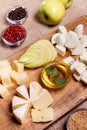 Cheese platter garnished with honey, apple and spice Royalty Free Stock Photo