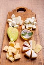 Cheese platter garnished with honey, apple and spice Royalty Free Stock Photo