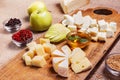 Cheese platter garnished on rustic wooden board Royalty Free Stock Photo